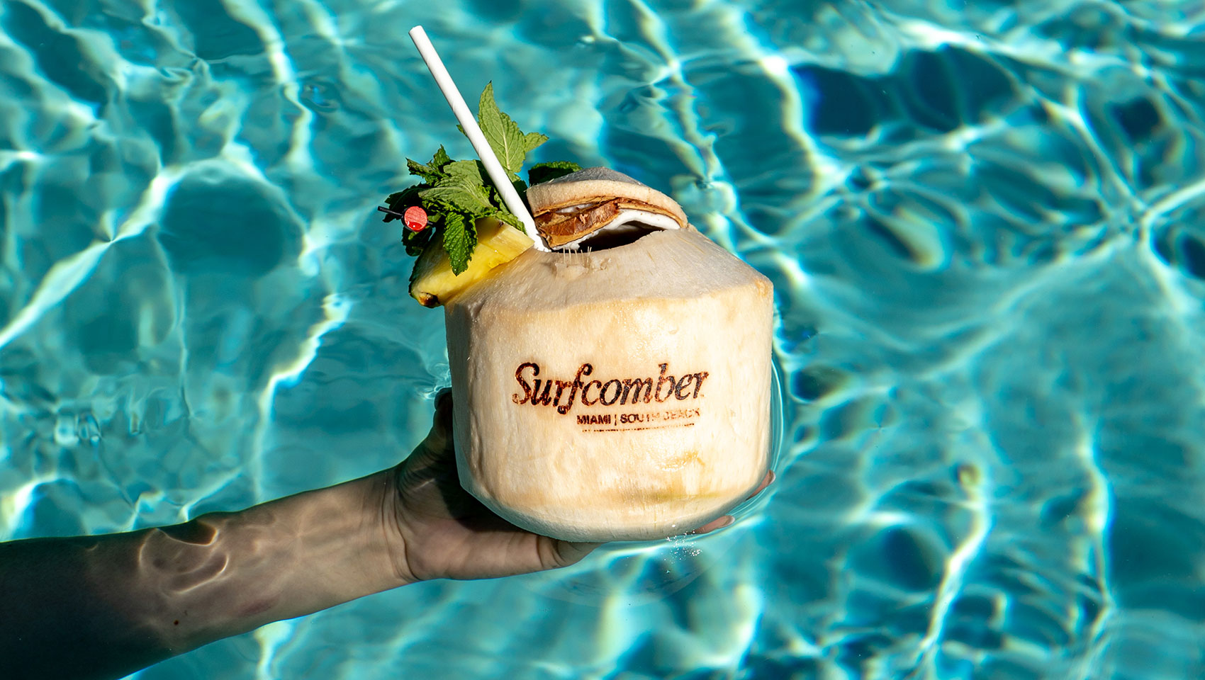 Coconut cocktail in front of pool