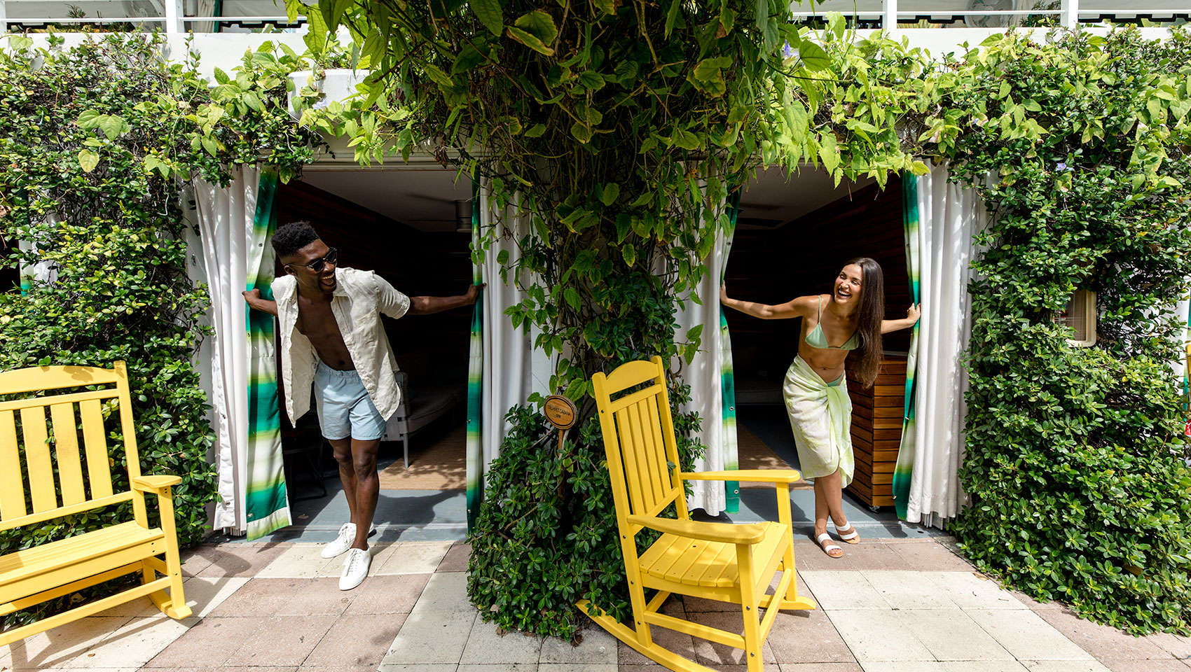 couple poking heads out in cabana