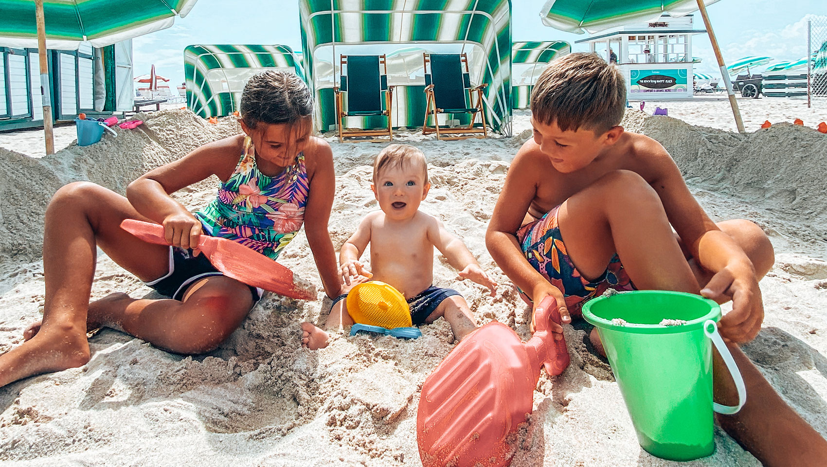 3 kids with beach toys