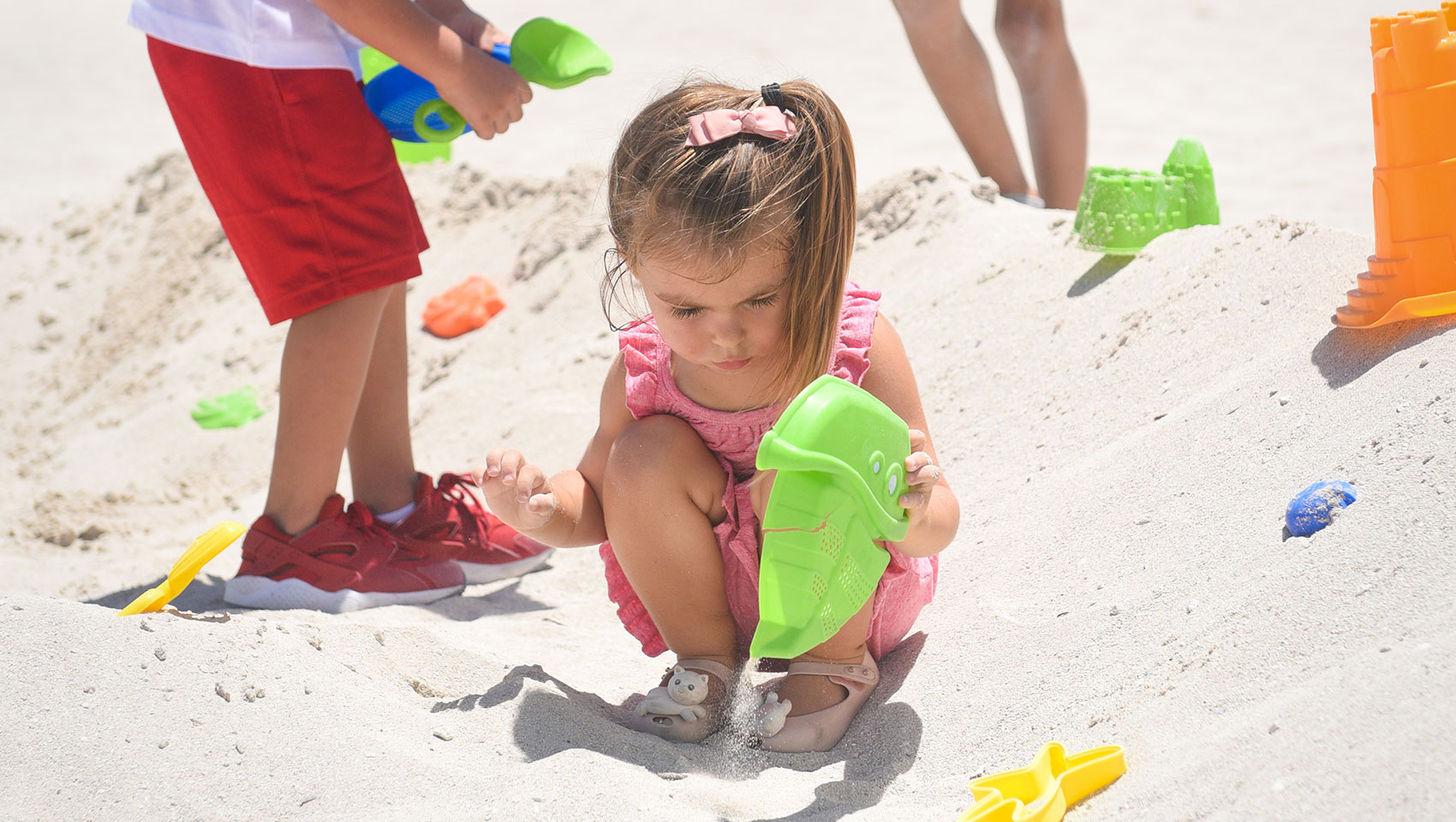 children playing in the sand with surfcomber beach toys