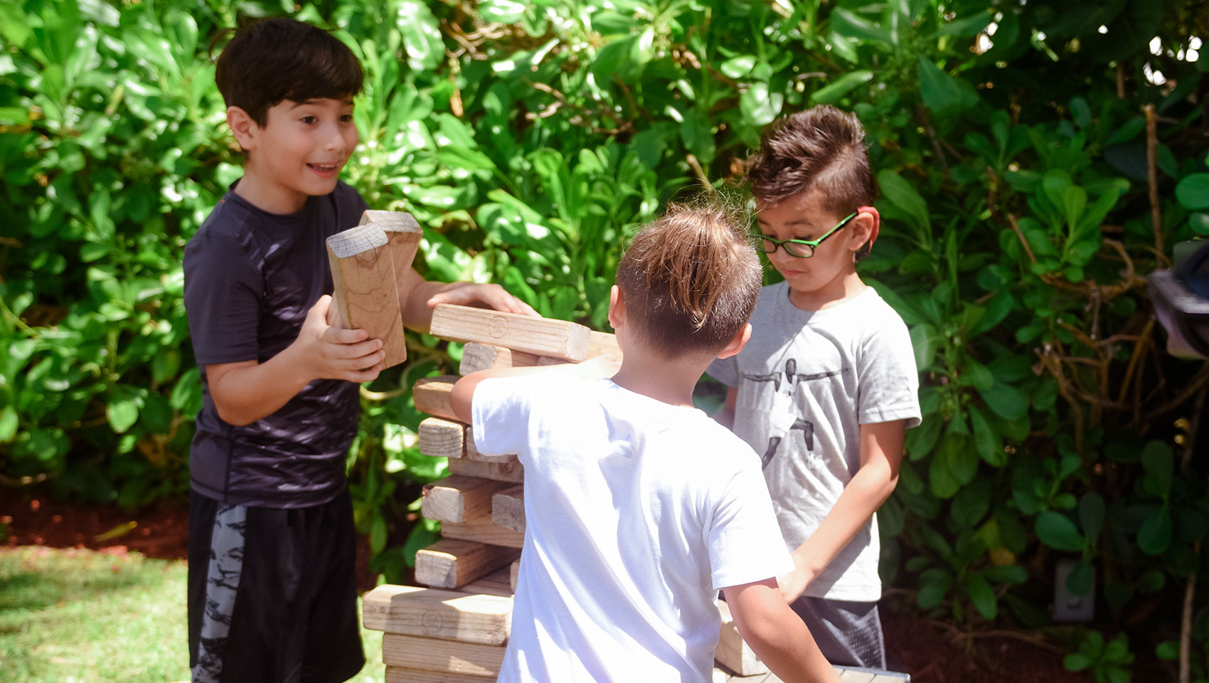 Surfcombers life size jenga game played by three boys