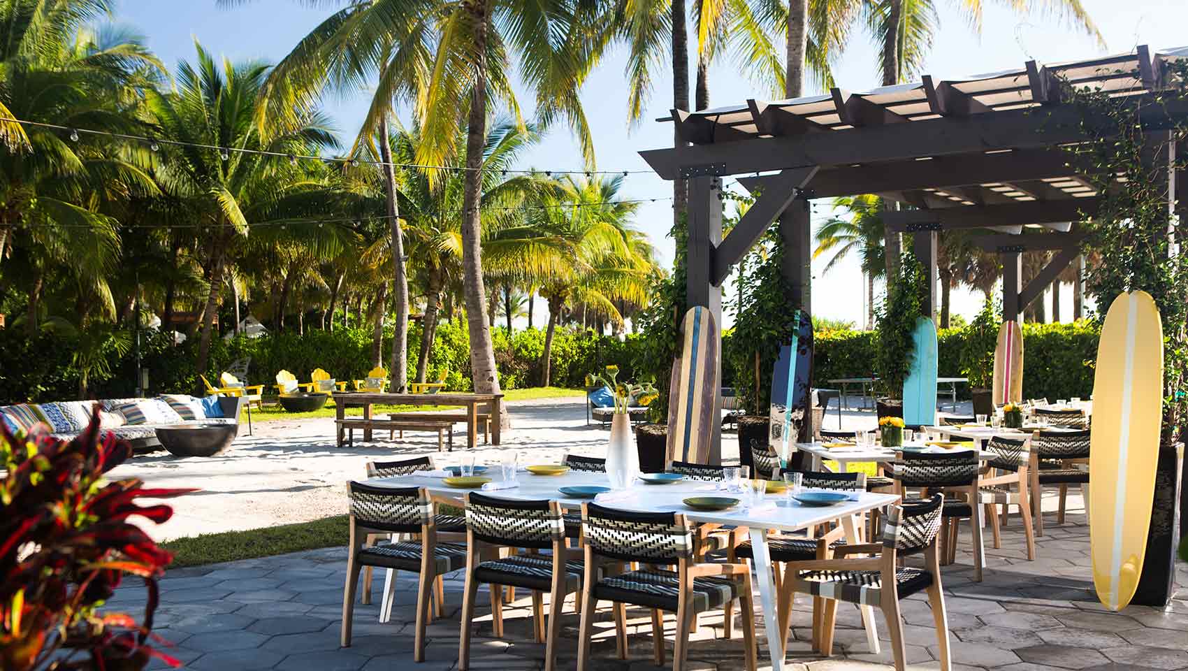 pool and lounge chairs with palm trees and clounds in the sky