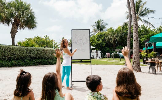 Kids play Pictionary outdoors at Kimpton Surfcomber